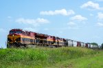 A northbound grain train passes through the tiny town of Hillje